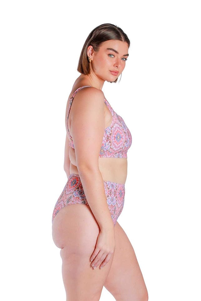 Model showing side view of pink and red toned high waisted bikini bottoms