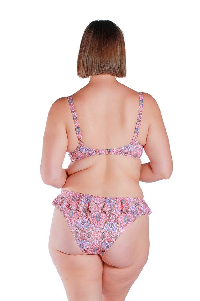 Model wearing pink and red toned frill top bikini pants
