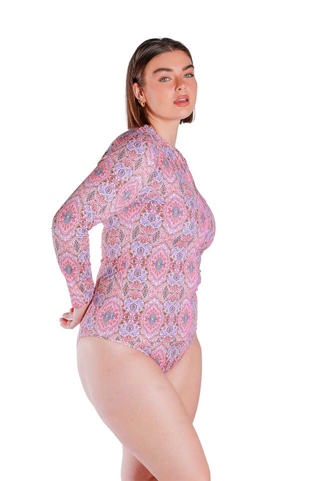 Side Shot of model wearing the pink printed long sleeved rash vest 