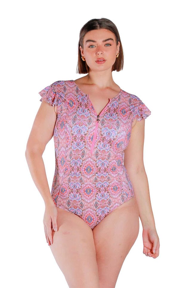 Front Shot of model wearing pink and red toned frilled sleeve one piece with zip front 