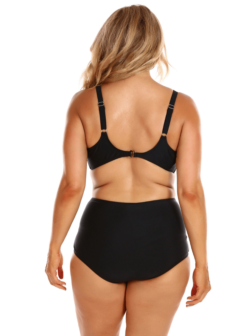 Person wearing a black bikini set on a white background