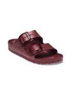 A single metallic burgundy double-strap slide sandal with black buckle details, shown from a three-quarters angle on a white background.