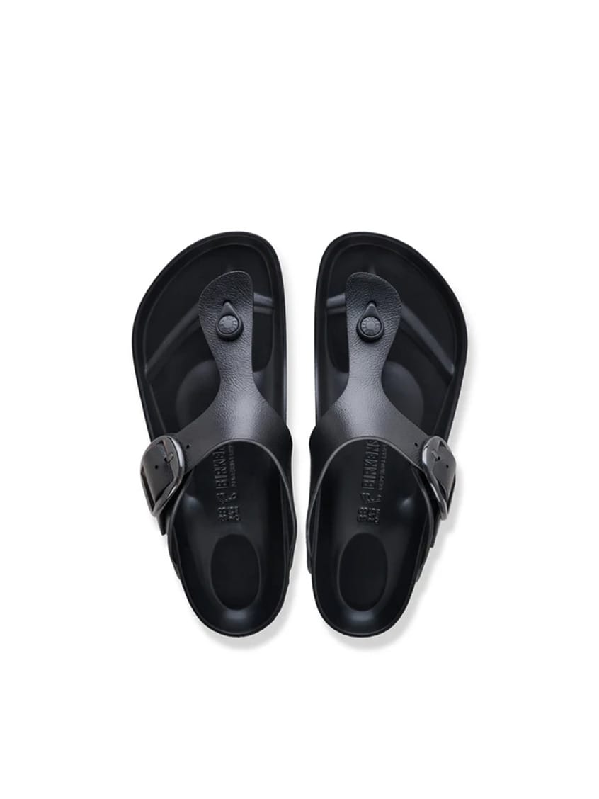 A pair of black  slide sandals shown from a top-down view on a clean white background.
