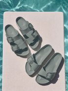 Gorup shot of birkenstock sandals by pool in sage