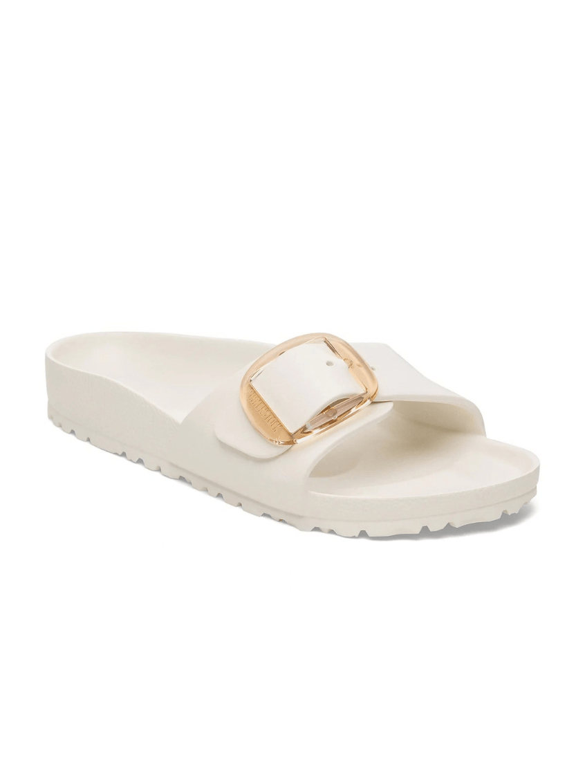 A single white slide sandal with a wide strap featuring a gold-tone square buckle, shown from a side profile on a white background.