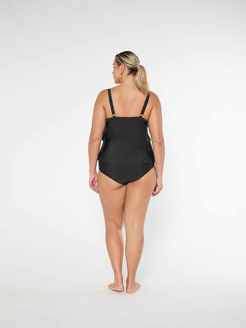 Woman wearing a black swimsuit on a white background