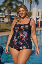 Blonde model wearing black floral tankini top at pool