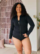 Model wearing a black long sleeve sun safe rashie in chlorine resistant