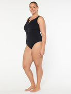 Woman wearing a black swimsuit on a white background