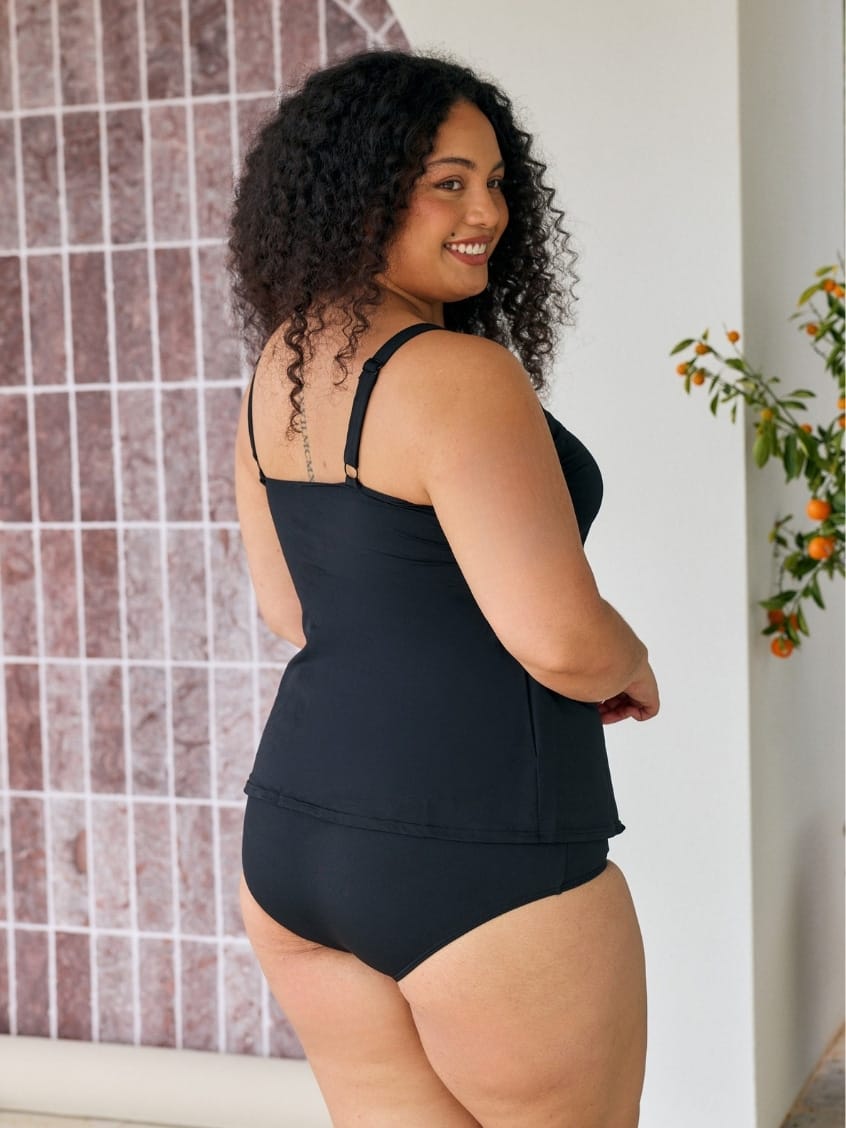 Back of model showing off black chlorine resistant tank tankini top with adjustable straps