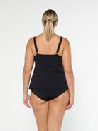 Blonde model shows the back of black pool proof tankini top with adjustable straps