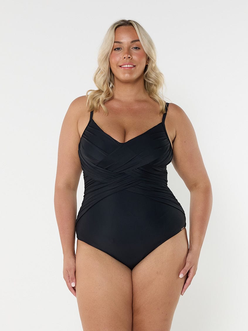 Blonde model wearing black criss cross one piece