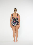 Woman wearing a floral swimsuit on a white background