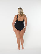 Person wearing a black swimsuit on a white background