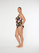 Woman wearing a floral swimsuit on a white background
