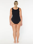 Person wearing a black swimsuit on a white background