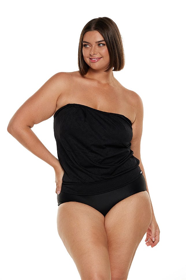 Brunette model wears flattering strapless bandeau tankini top in black textured fabric