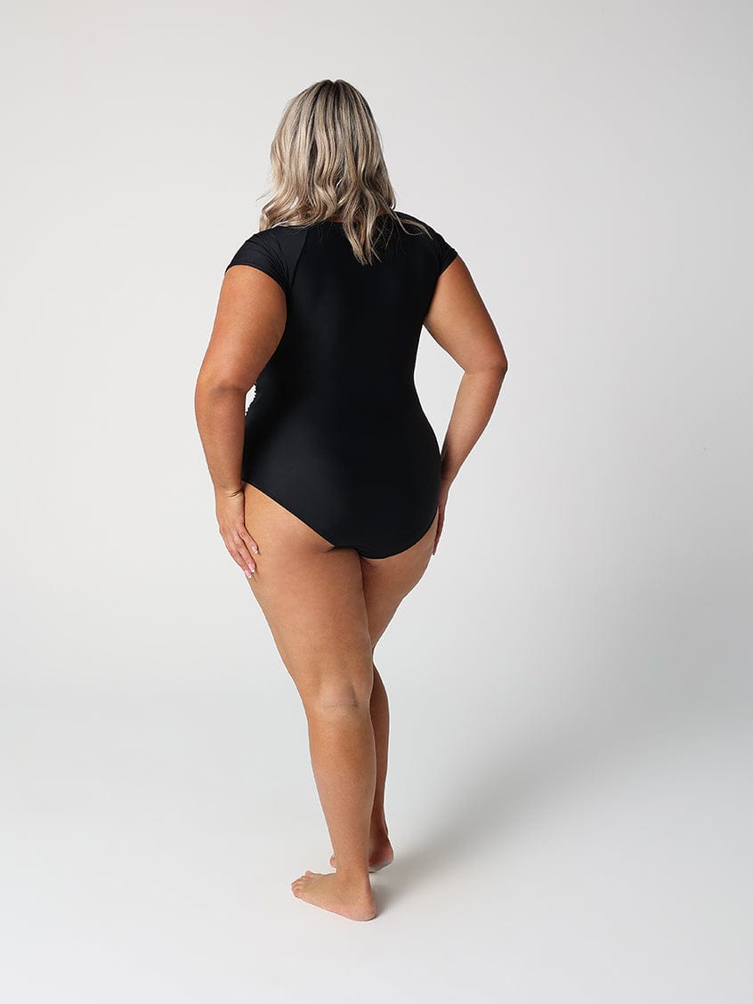 Person wearing a black swimsuit on a white background