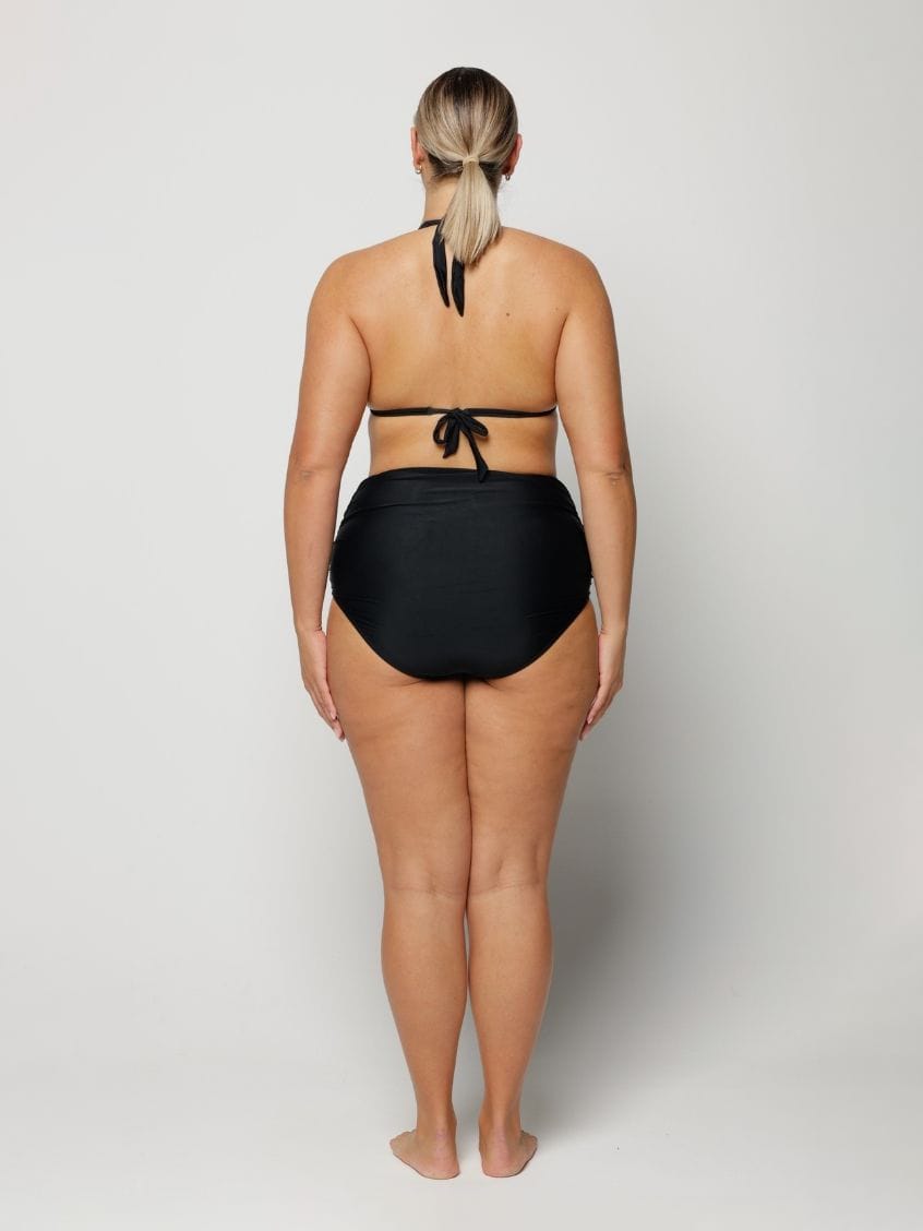 Person wearing a black bikini on a white background