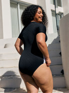 Back of model showing off model high neck one piece with textured black and white print in chlorine resistant