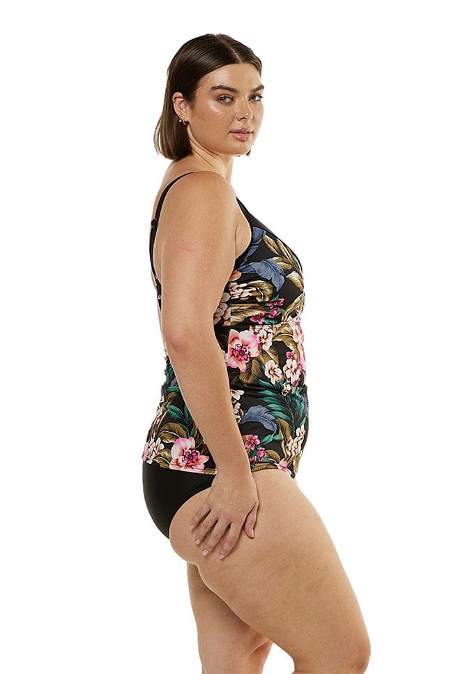side of model wearing tropical print tankini swimwear