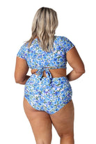Model wearing blue floral full coverage swim bottoms