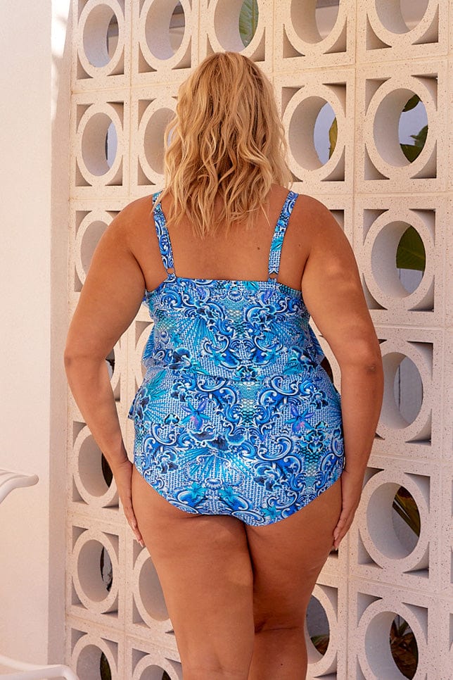 Blonde model showing back of blue tankini top