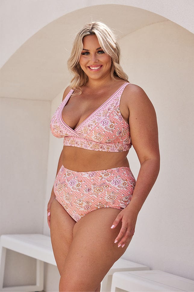 Blonde model wearing blush pink floral bikini top and high waisted pant