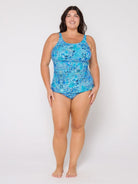 Woman wearing a blue patterned swimsuit on a white background