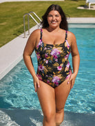Woman in a floral swimsuit standing by a pool