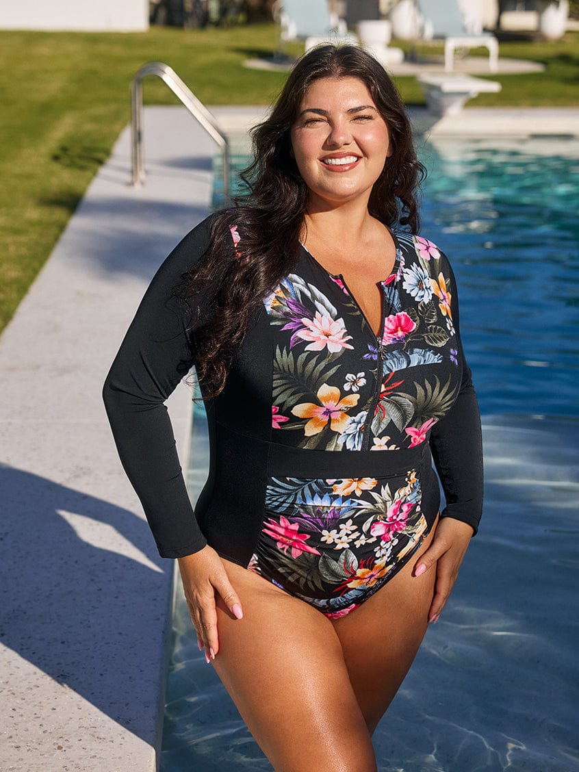 Woman wearing a floral swimsuit by a pool