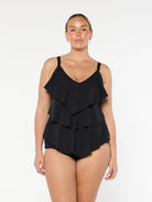 Blonde model wears black chlorine resistant tankini top