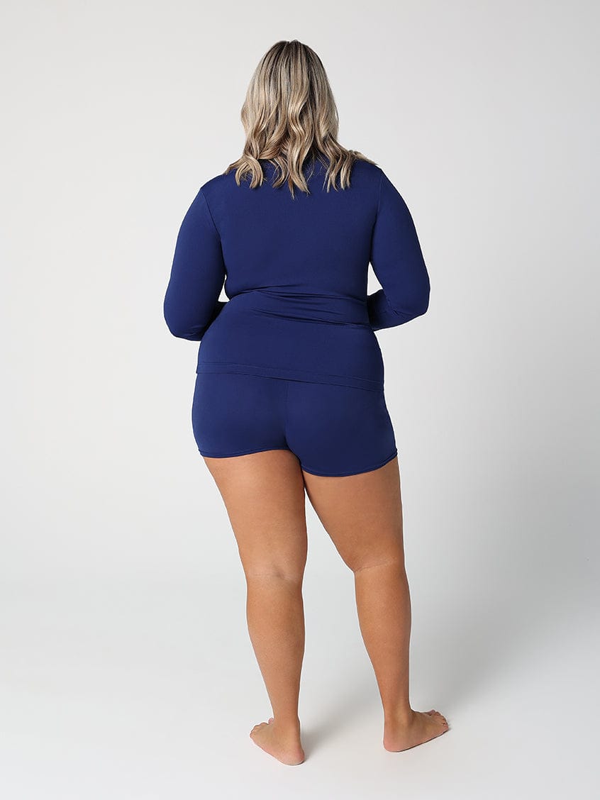 Person wearing a blue swimsuit on a white background