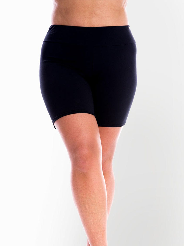 Model in studio wearing black chlorine resistant boyleg swim pant