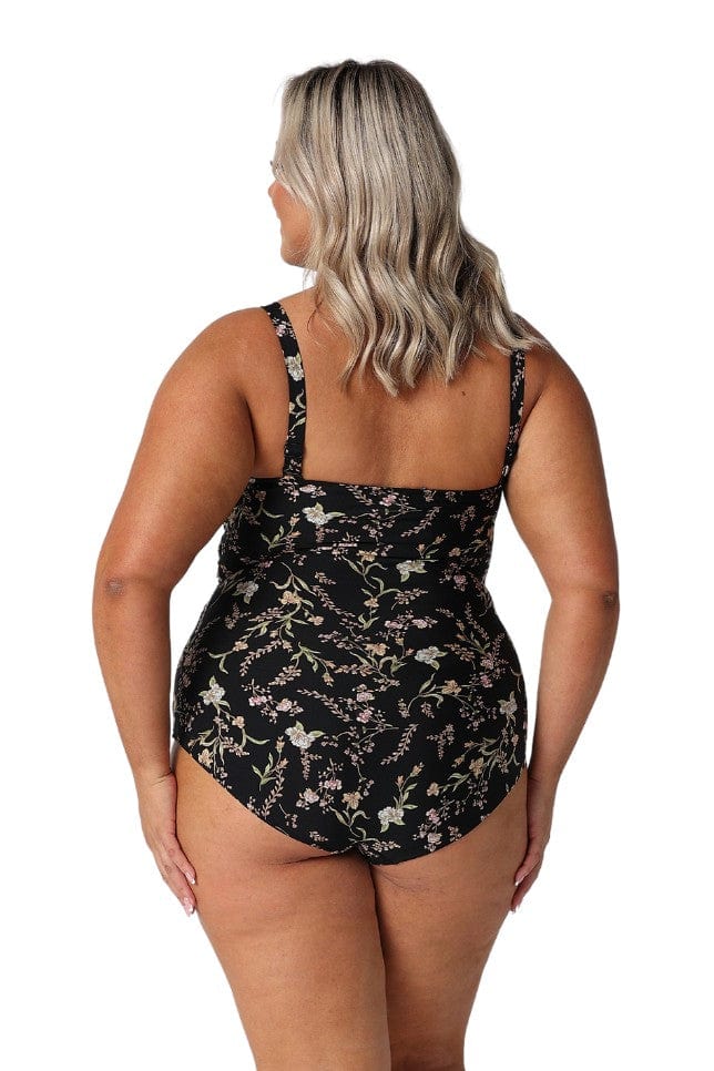 Model showing back of black floral full coverage swimsuit