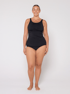 Person wearing a black swimsuit on a white background