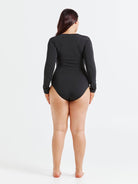 Black chlorine-resistant long sleeve one piece swimsuit with zip front and UPF 50+ sun protection, shown on model standing back on