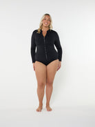 Woman wearing a black zip-up swimsuit on a white background