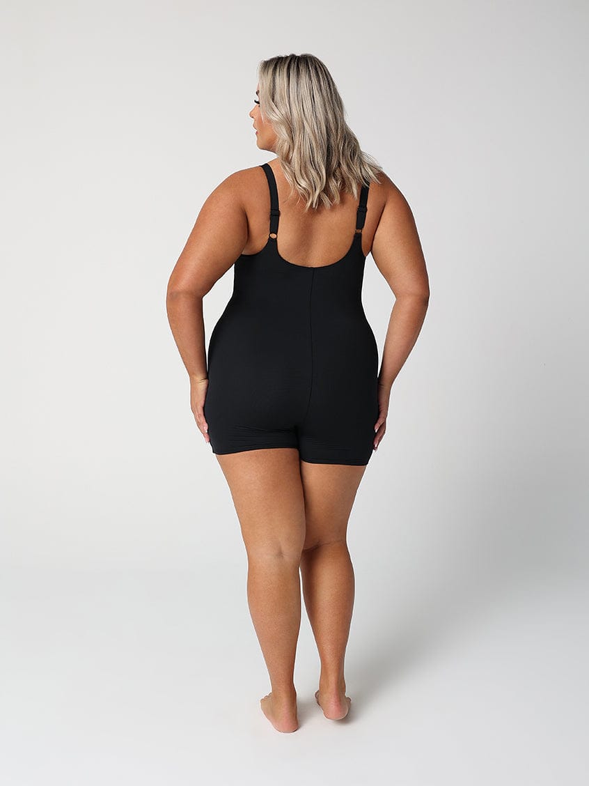 back of model wearing black boyleg one piece