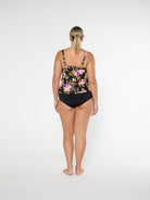 Woman wearing a floral swimsuit on a white background