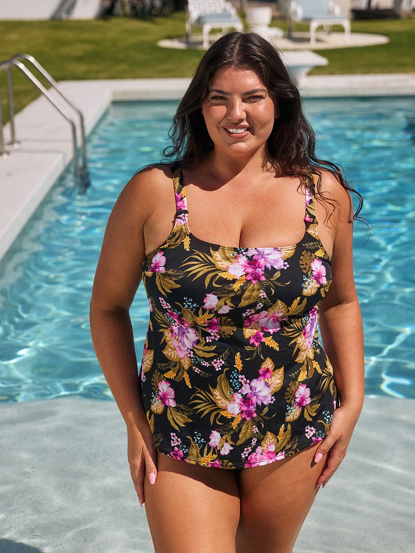 Woman wearing a floral swimsuit by a pool