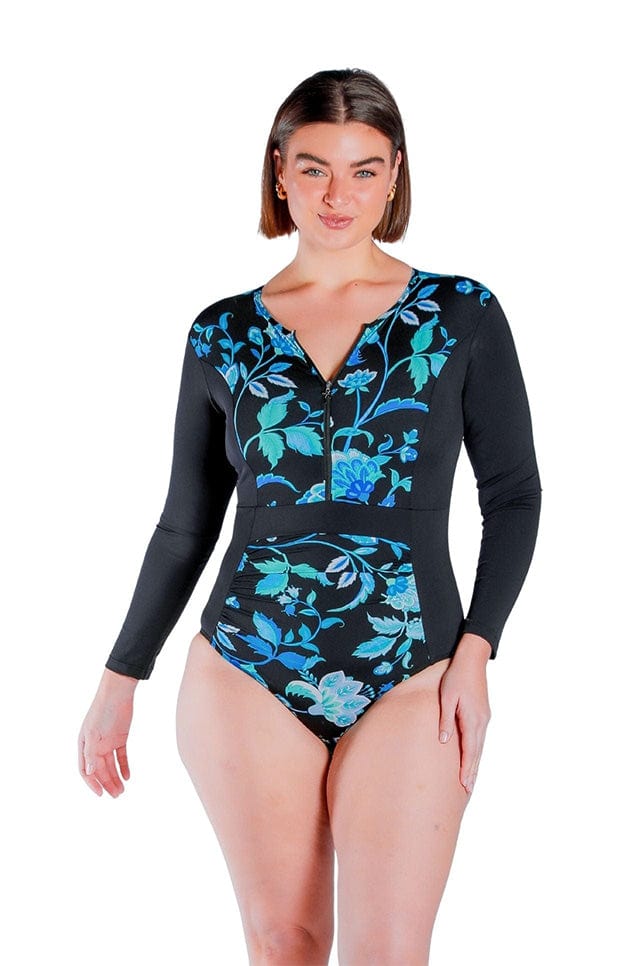 brunette model wearing size 12 long sleeve one piece bathing suit in turquoise and black floral