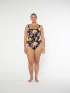 Woman wearing a floral swimsuit on a white background