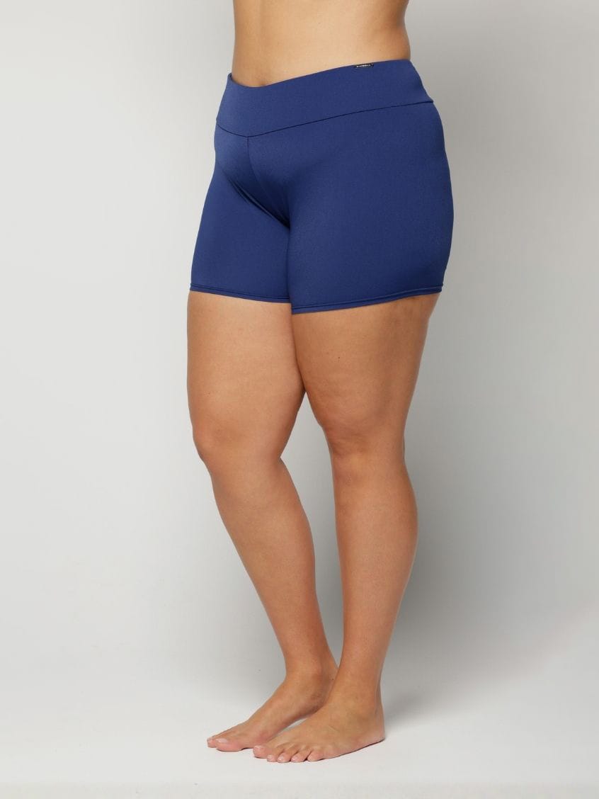 Blue chlorine resistant swim shorts worn by a person on a plain background