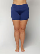 Person wearing blue swim shorts on a plain background
