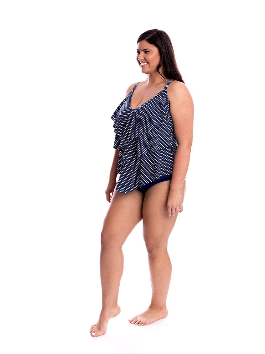 Woman wearing a navy patterned swimsuit on a white background