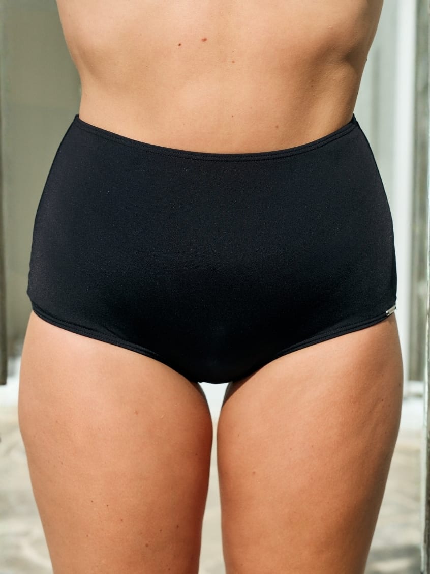 Model wearing a black high waisted flattering swim pant