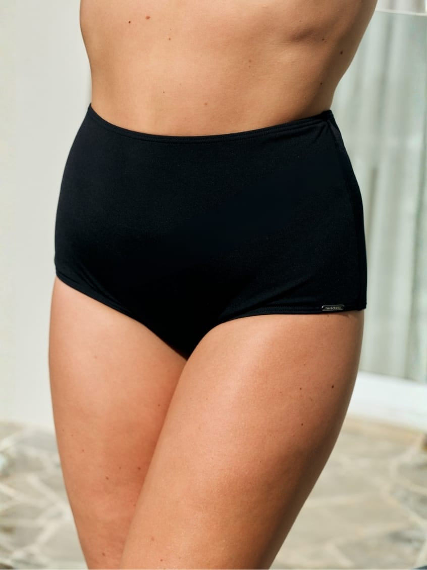 Side of model wearing a flattering high waisted swim pant with chlorine resistant fabric