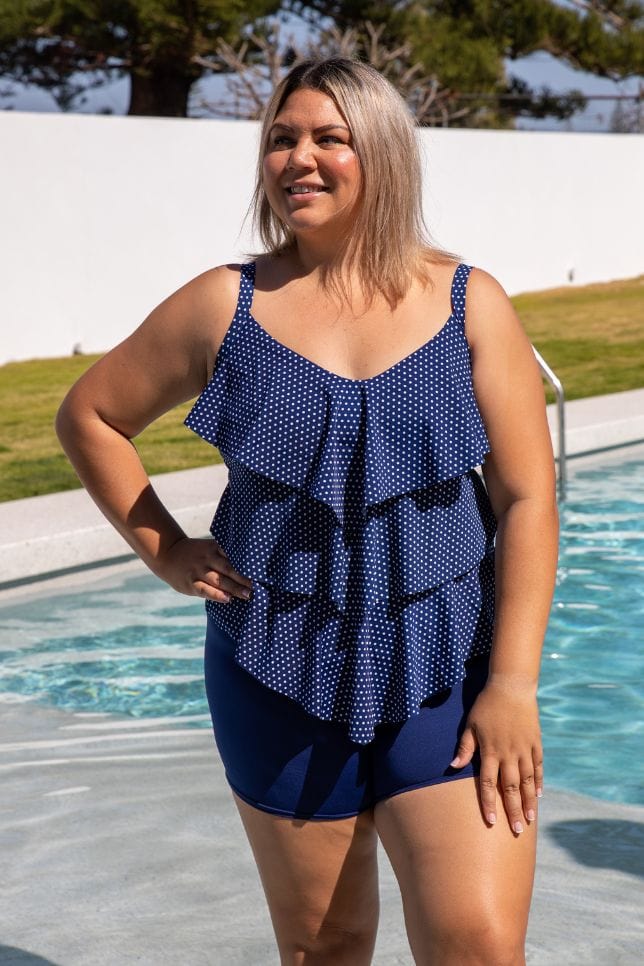 Blonde model wearing modest navy boy leg swim pant