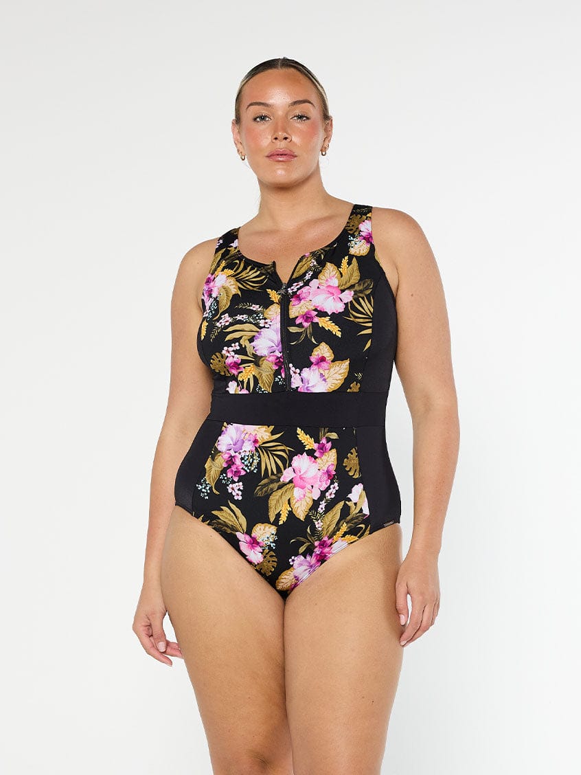 Blonde model wears sleeveless chlorine resistant pink floral one piece with front zip 